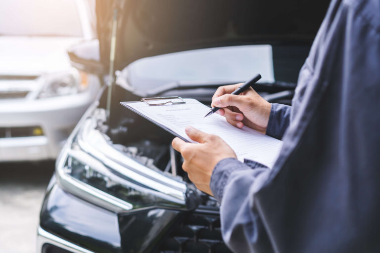 Man inspecting a vehicle looking at the 4 critical checks to buy a second-hand car safely.