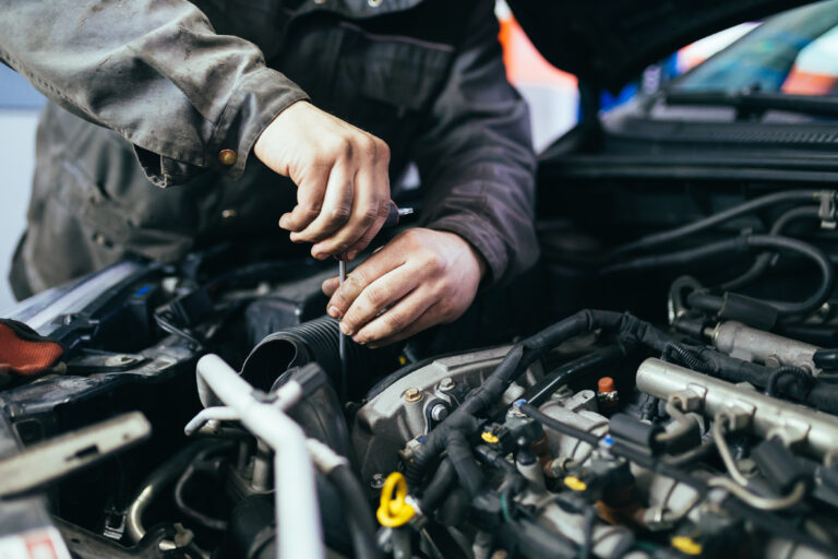 A car engine having its oil levels checked at a workshop.