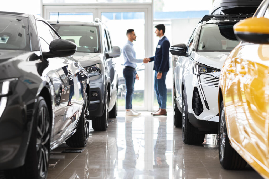 A man at a car dealership agreeing to get a vehicle warranty for car protection