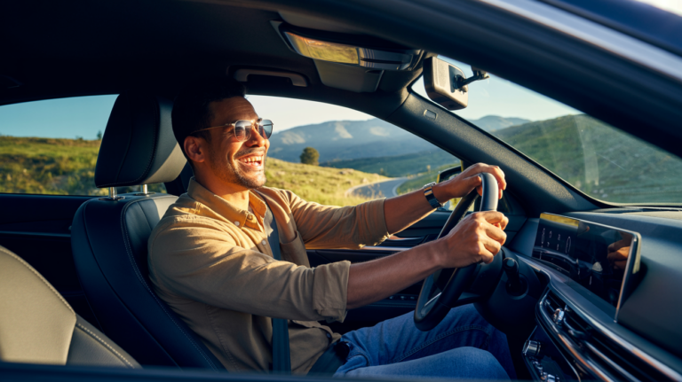 A middle-aged man driving a new vehicle to a destination near Joburg